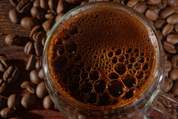 istock Hot black coffee and coffee beans  on the old wooden table 1297468028