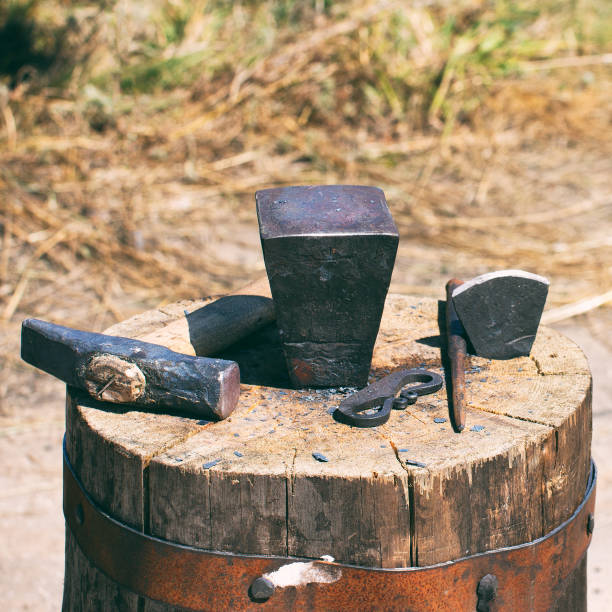 istock The old tools of a blacksmith on large wooden stump 1297468571