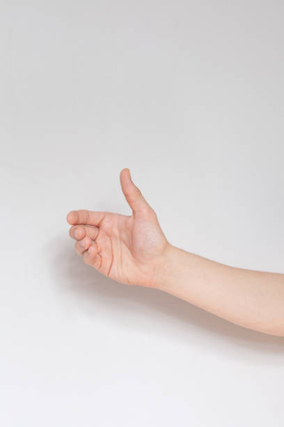 istock Close up hand holding something like a bottle or can isolated on white background. 1297468961