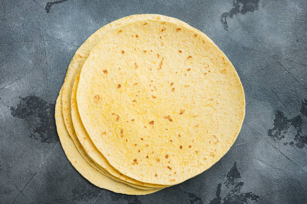 istock Fresh yellow corn tortillas, on gray background, top view flat lay  with copy space for text 1297469154