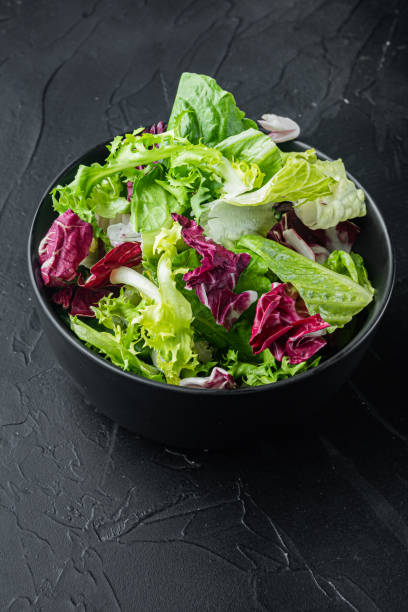istock Frieze, romaine and Radicchio lettuce, on black background 1297471000
