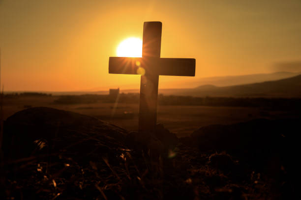 istock Cross in front of mountains 1297472580