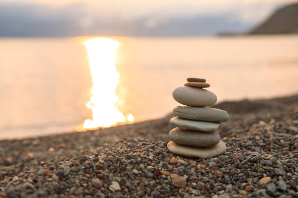 istock Pyramid of smooth stones on the beach 1297472590