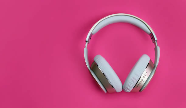 istock wireless headphones on pink background 1297473568