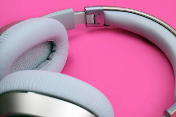 istock wireless headphones on pink background 1297473621