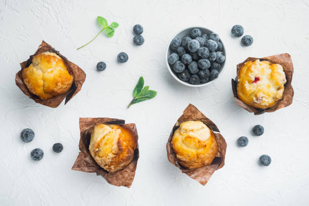 istock Homemade muffins with fresh blueberries, on white background, top view flat lay 1297473668