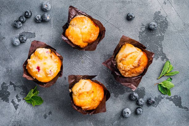 istock Homemade muffins with fresh blueberries, on gray background, top view flat lay 1297474034