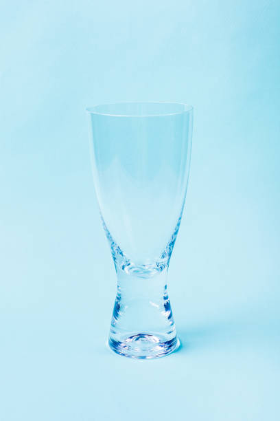 istock Empty glass from transparent glass on a blue background. 1297474254