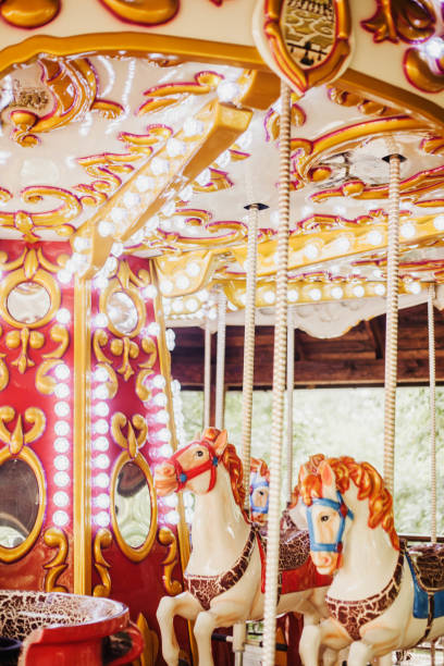 istock Carousel with horses. Bright swing for children. Amusement park 1297475209