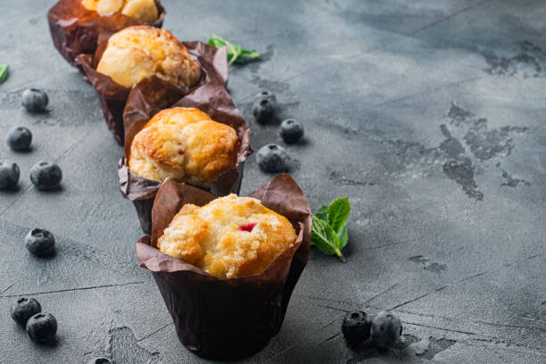 istock Homemade muffins with fresh blueberries, on gray background with copy space for text 1297476437