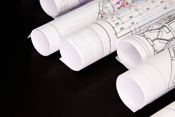 istock Architectural project, drawings on a dark background. Rolls of project drawings 1297479111
