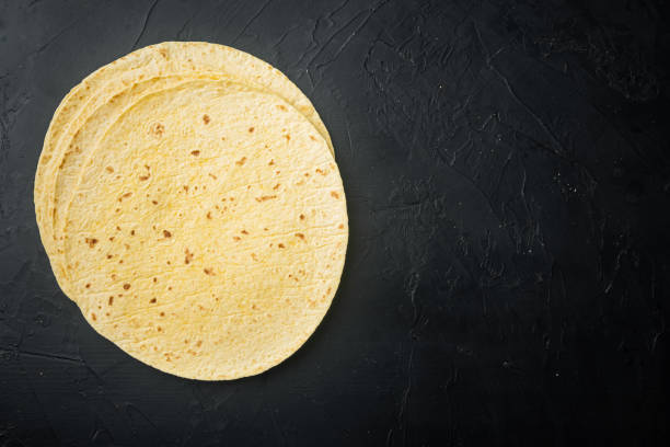 istock Mexican corn tortillas, on black background, top view flat lay with copy space for text 1297479305