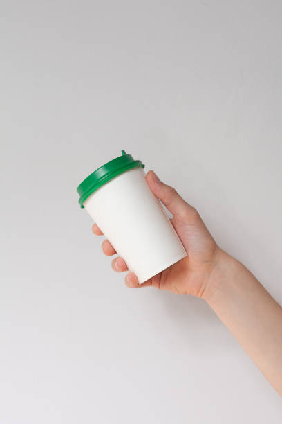 istock Take away coffee cup background. Male hand holding a coffee paper cup 1297479612