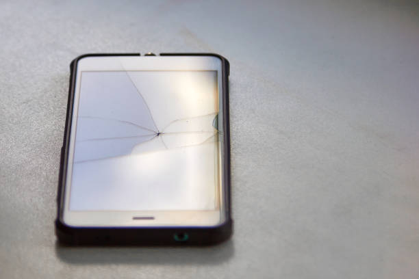 istock Colored highlights of a broken mobile phone screen in the reflection of daylight 1297481301