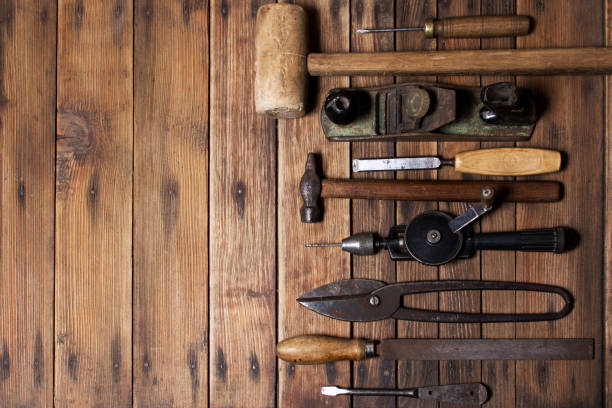 istock Old carpenter hand tools on wooden plank background 1297482285