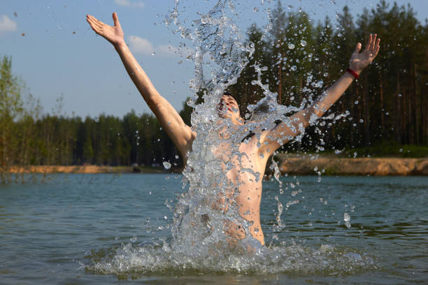 cute boy happily bathes in the water.