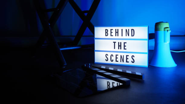 istock Behind the scenes letterboard text on Lightbox or Cinema Light box. Movie clapperboard megaphone and director chair beside. Background LED color change loop. static camera in video production studio. 1297482698