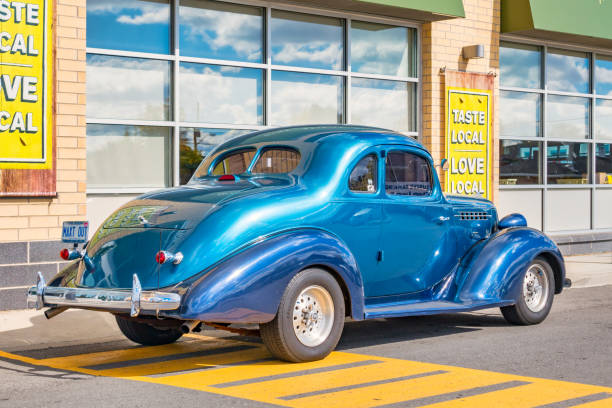 A blue colored 1936 Hudson Terraplane Deluxe coupe car is parked on a street in Hamilton, Ontario, Canada on a sunny day