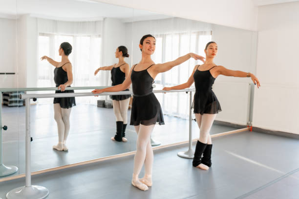 istock Ballets dancers stretching at barre 1297486673
