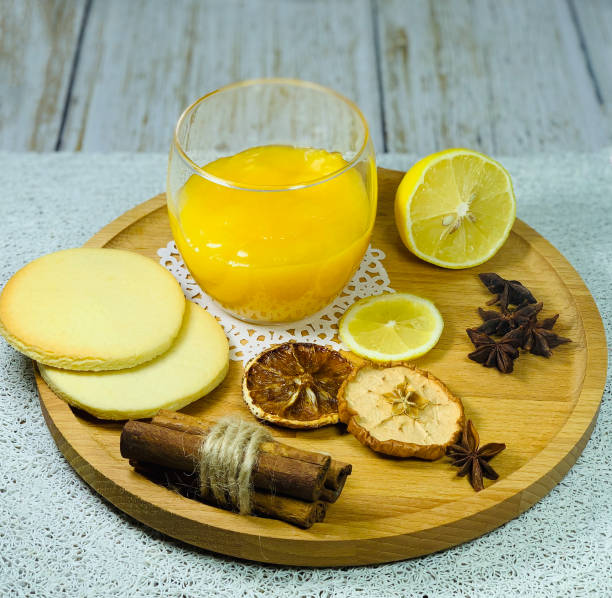 istock Lemon Kurd with cookies on a wooden plate. 1297486885