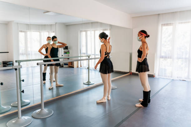 istock Ballets dancers stretching at barre 1297487735