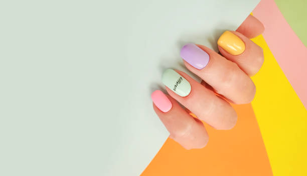 istock female hand beautiful manicure on a colored background 1297490246