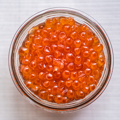Salmon eggs in a glass jar