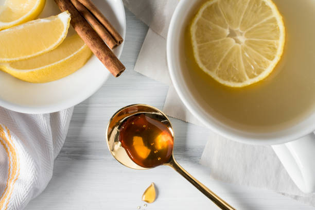Hot Soothing Lemon and Honey Drink Hot Soothing Lemon on Honey Drink sooth stock pictures, royalty-free photos & images