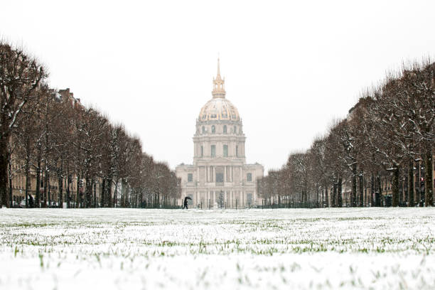 View to Les Invalides church ( Saint Louis ) with snow. Unusual weather conditions in Paris. Avenue de Breteuil,  in Paris 7, France, January 16, 2021.