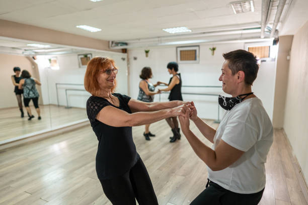 istock Group of senior women dancing in studio while exercising in dancing class 1297491789