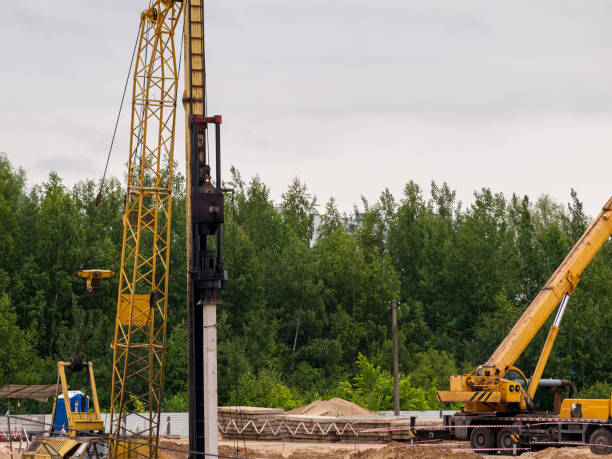 istock Drop hammer while working on driving piles, diesel hammer strikes a series of blows on a concrete pile, Foundation construction using iron concrete piles 1297492478