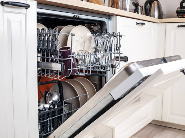dishwasher close-up with washed dishes, easy to use and save water, eco-friendly, built-in kitchen dish washing machine stock photo