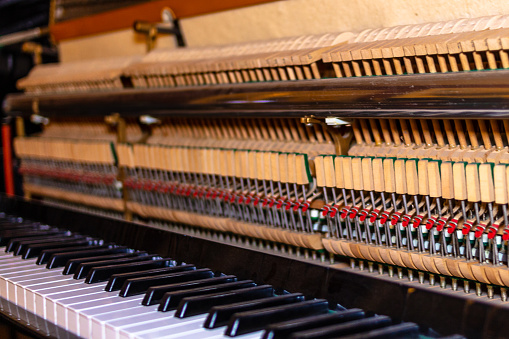 Vertical piano with visible gears