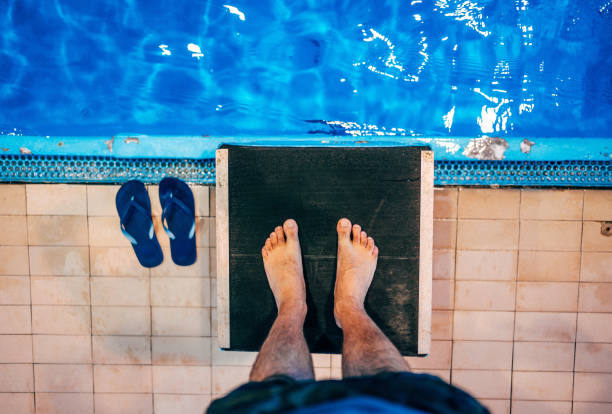 istock Swimmer on a swimming starting block 1297495261