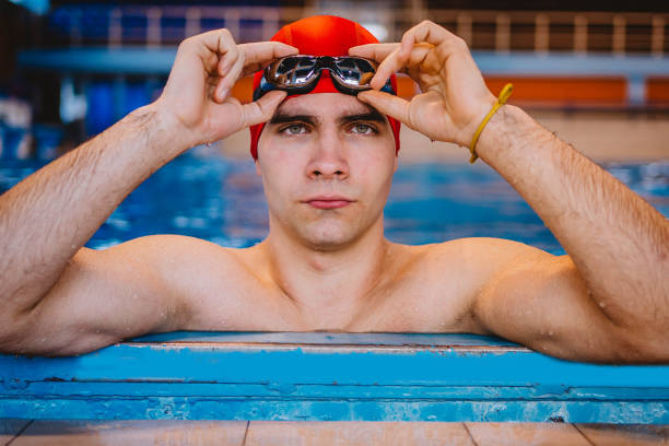 istock Young man on the edge of pool 1297495275