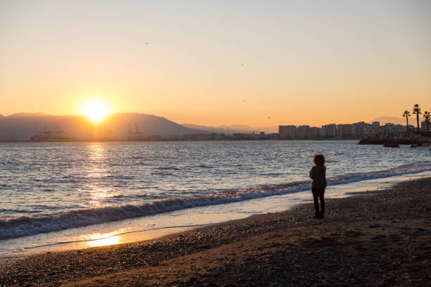 istock Woman thinking and looking at the sea during sunset 1297496470