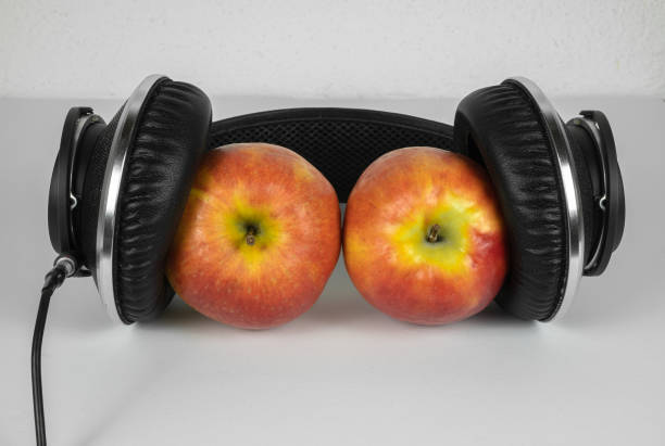 istock Two ripe juicy apples between the headphones 1297497118
