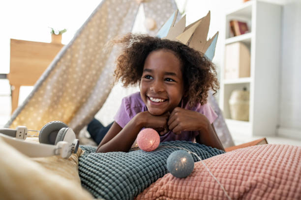 istock Happy young girl playing at home 1297497236