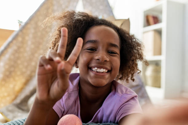 istock Happy young girl playing at home 1297497321