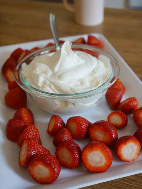 istock Strawberries and Whipped Cream on White Tray 1297497325