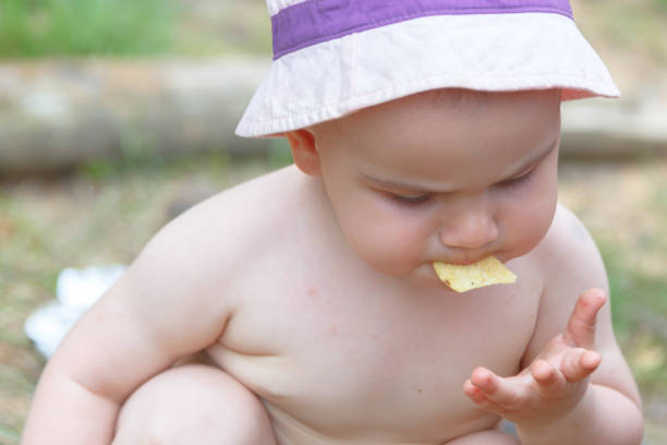 istock Small child eating summer lake weekend 1297498268
