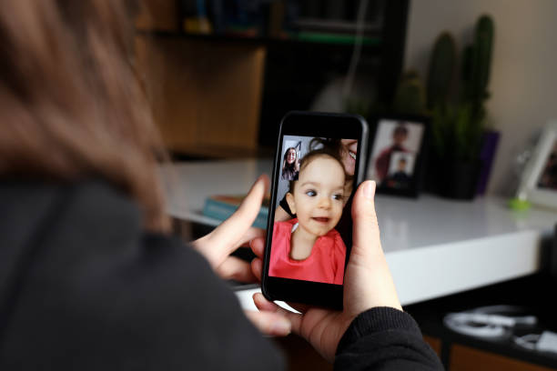 istock Baby girl is making a video call 1297499149
