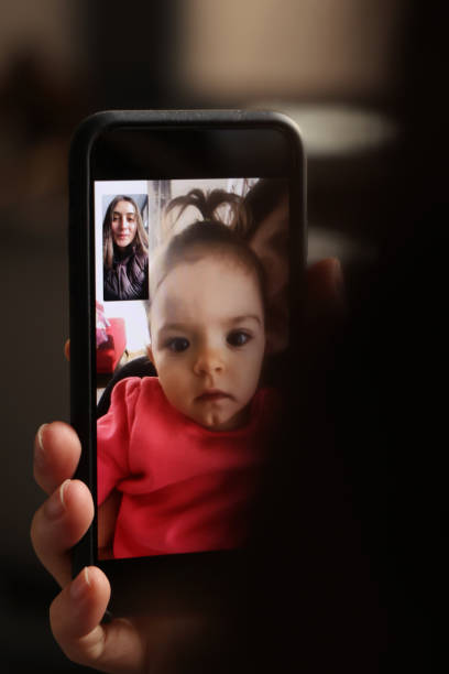 istock Baby girl is making a video call 1297499403