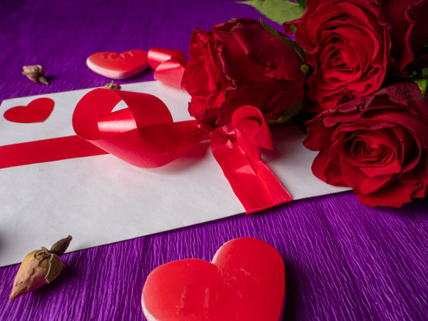 istock red roses on purple background 1297499463