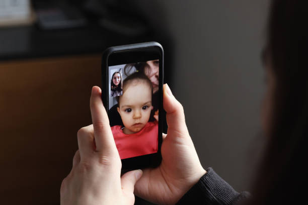 istock Baby girl is making a video call 1297499474