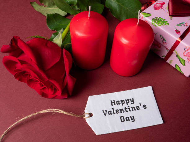 istock A large red rose which is next to two red large candles 1297500217
