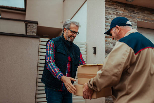 istock Delivery man delivering a package to the customer 1297501276