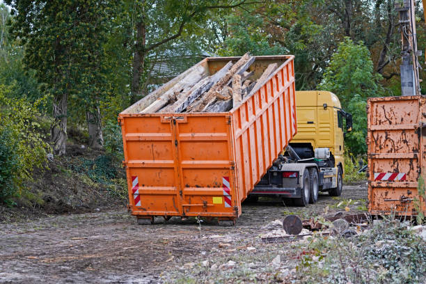 istock Trucks picking up a container and dumping building rubble 1297502714