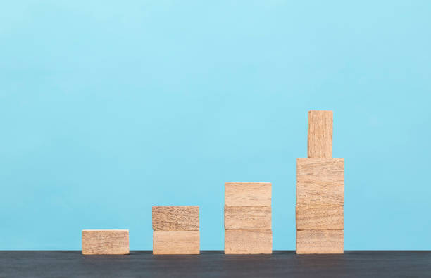 istock Wooden block stacking as step stair  on blue background 1297503361