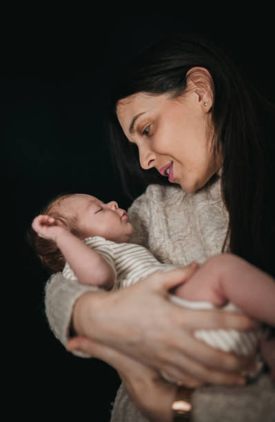 istock Mom is holding newborns 1297505246